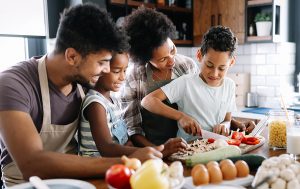 Happy family in the kitchen having fun and cooking together. 