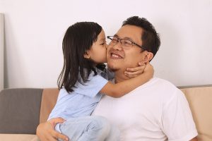 Asian father smiling while playing with his baby girl, dad and daughter love each other, happy single parent concept