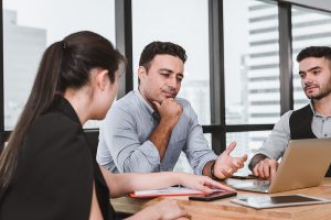 Married couple talking with a divorce attorney.