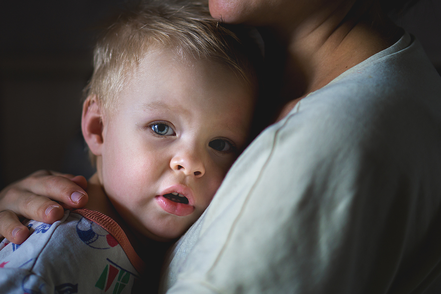 A tearful little boy clings to his mother to calm down. A mothers care and custody. The relationship between parents and children.