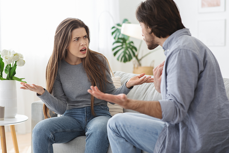 Angry married couple having fight, yelling at each other.