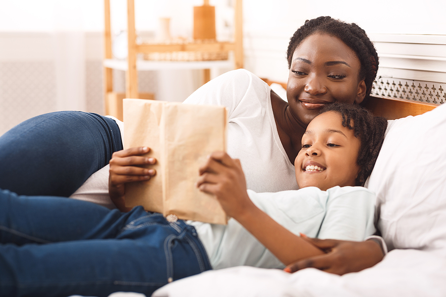 Mom and child reading a book together.