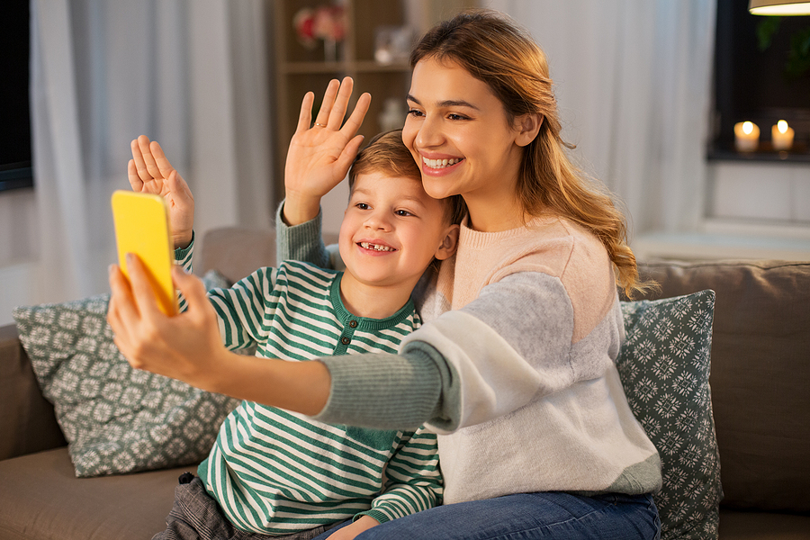 Single mom video calling her ex-husband to talk with their child in a positive way to be good co-parenting.