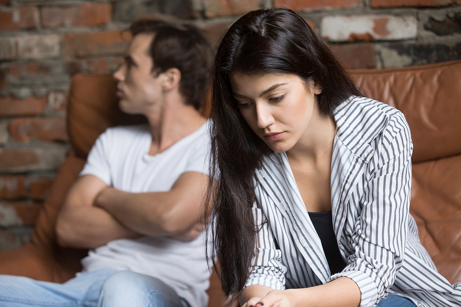 Unhappy young couple thinking about getting a divorce.