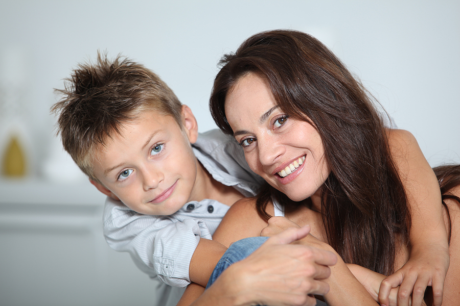 Closeup of mother and child smiling.