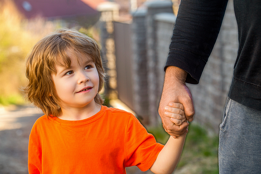 Child hand father. Hands of parent and child outdoors. Parent holds the hand of a small child. Fathers hand lead his child son, trust family concept. Parents holds the hand of a small child