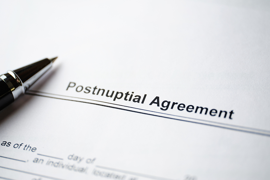 Legal postnuptial agreement with a pen lying on top of the form. 