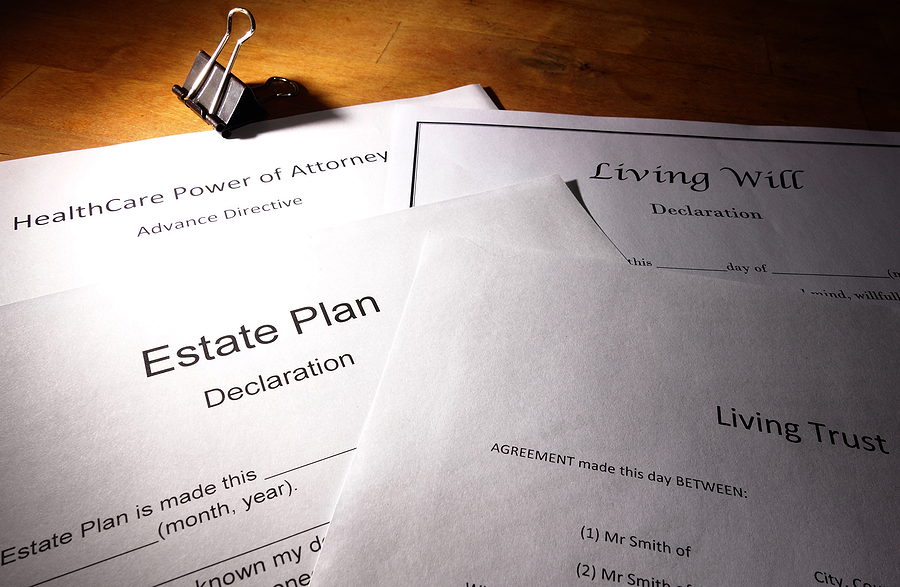 Estate planning documents lying on a desk, overlapping each other. 