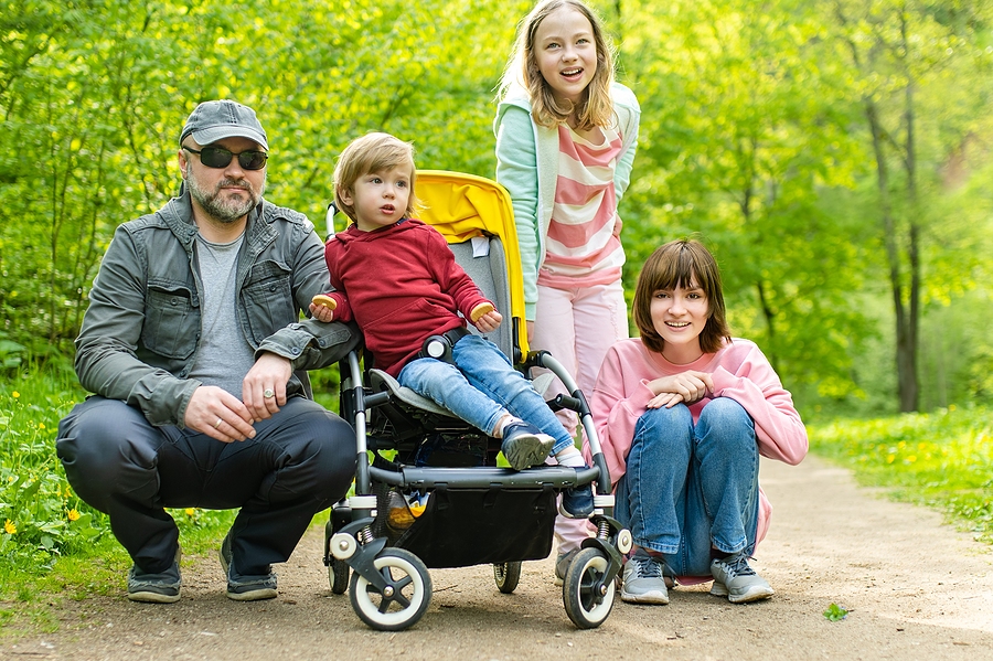Father with 3 children at a park who are different ages. 